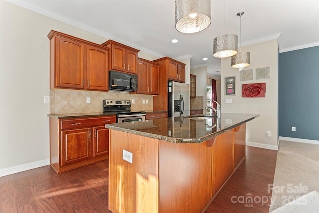 2439 Bergamot St, Fort Mill, SC 29708 - kitchen featuring dark wood-type flooring, a center island with sink, ornamental molding, appliances with stainless steel finishes, and a sink