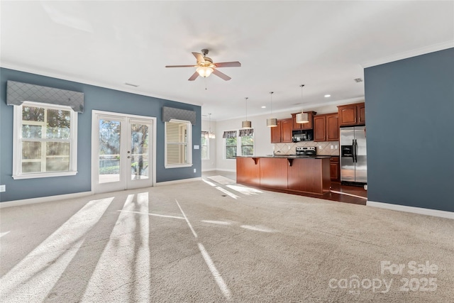 2439 Bergamot St, Fort Mill, SC 29708 - unfurnished living room featuring baseboards, carpet, crown molding, and ceiling fan