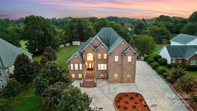 view of front of house featuring concrete driveway and brick siding