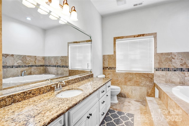 full bath featuring a garden tub, toilet, vanity, visible vents, and tile walls