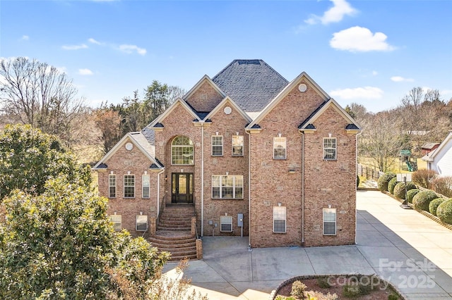 traditional-style home featuring a patio and brick siding