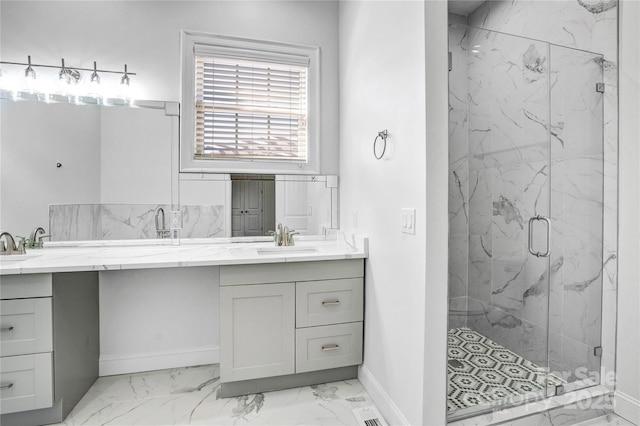 bathroom with marble finish floor, double vanity, a sink, and a marble finish shower