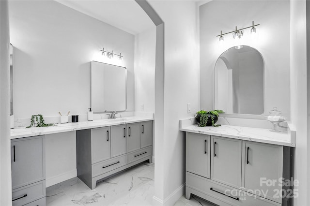 full bathroom featuring marble finish floor, vanity, and baseboards