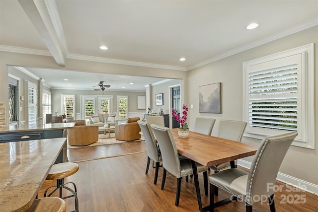 dining space with crown molding, french doors, light wood finished floors, and recessed lighting