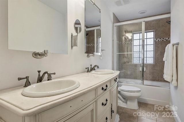 full bath featuring enclosed tub / shower combo, a sink, toilet, and tile patterned floors