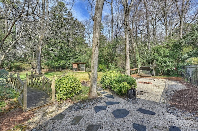 view of yard featuring fence and an outdoor structure