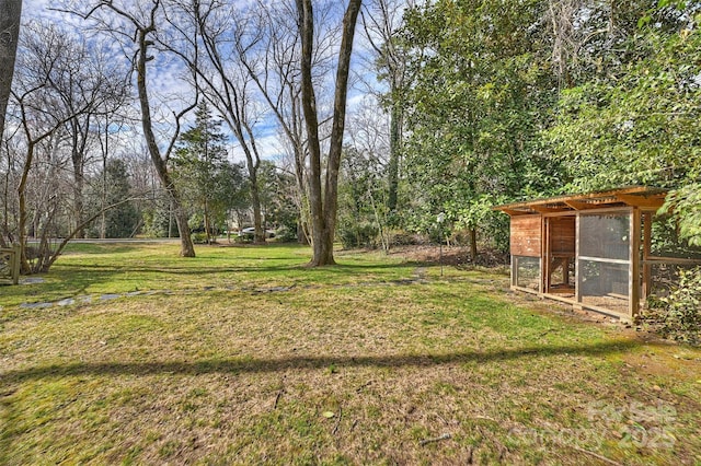 view of yard featuring exterior structure and an outbuilding