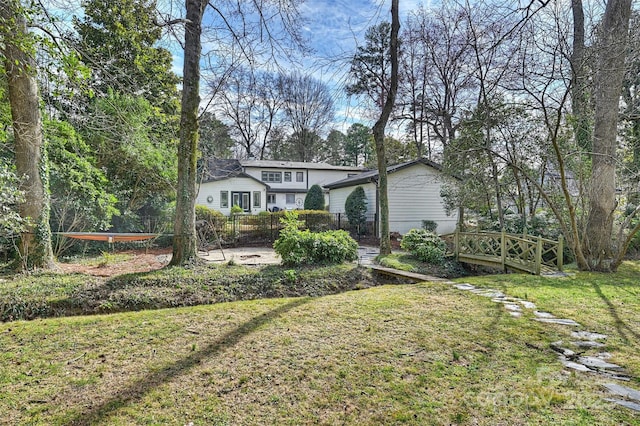 exterior space featuring fence and a front lawn