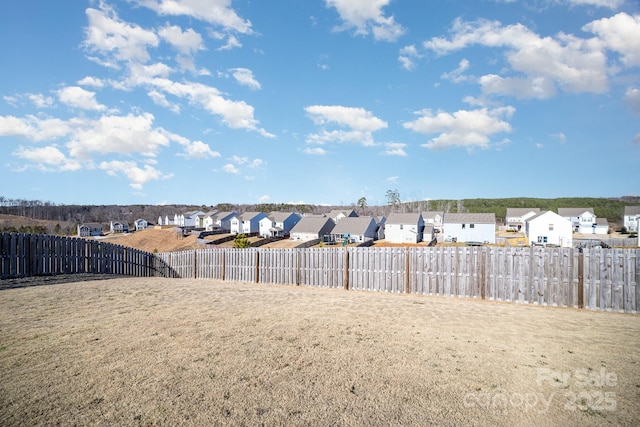 view of yard with fence and a residential view