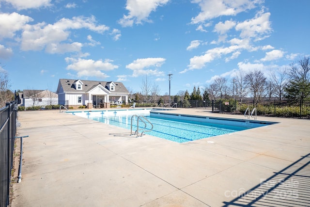 pool with fence and a patio