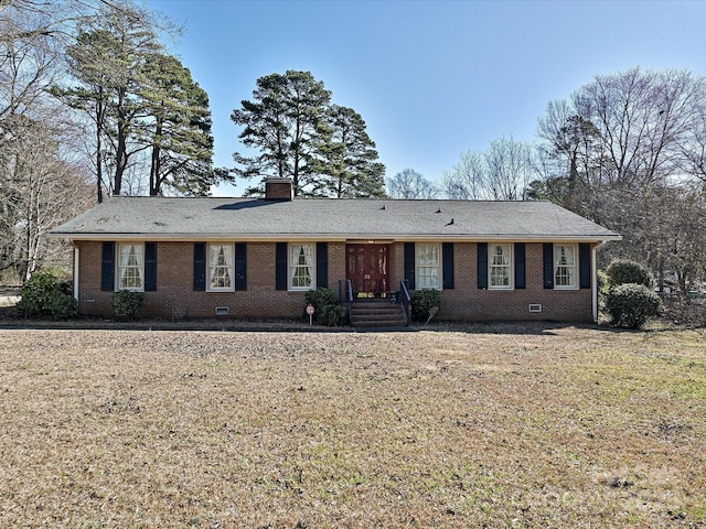 ranch-style house featuring crawl space, a front yard, a chimney, and brick siding