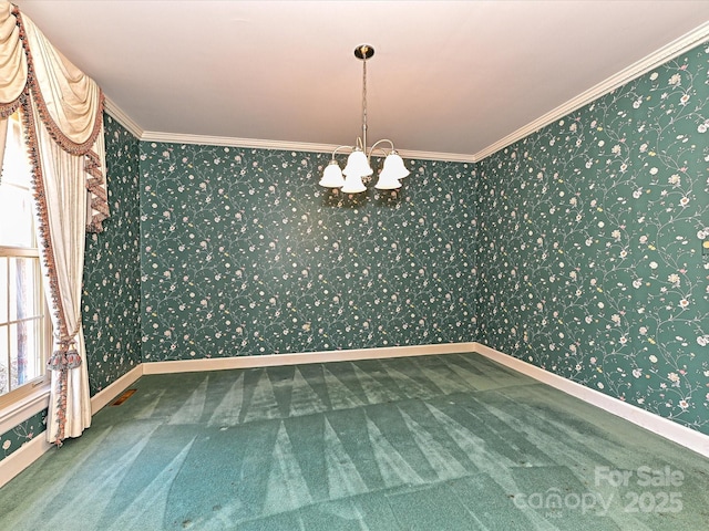 carpeted empty room with wallpapered walls, a chandelier, and crown molding