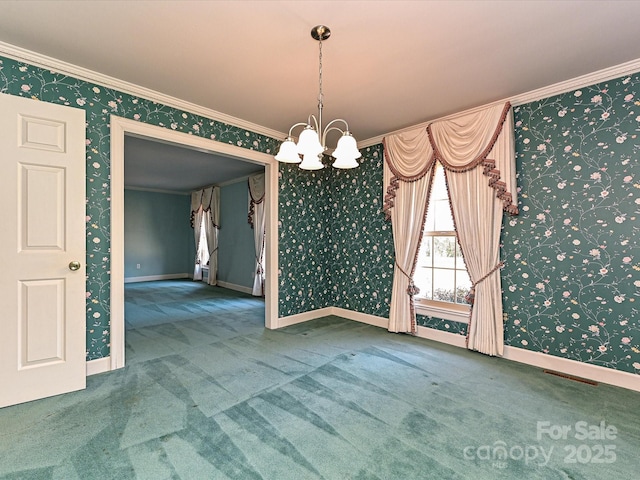 spare room with a chandelier, baseboards, ornamental molding, carpet, and wallpapered walls