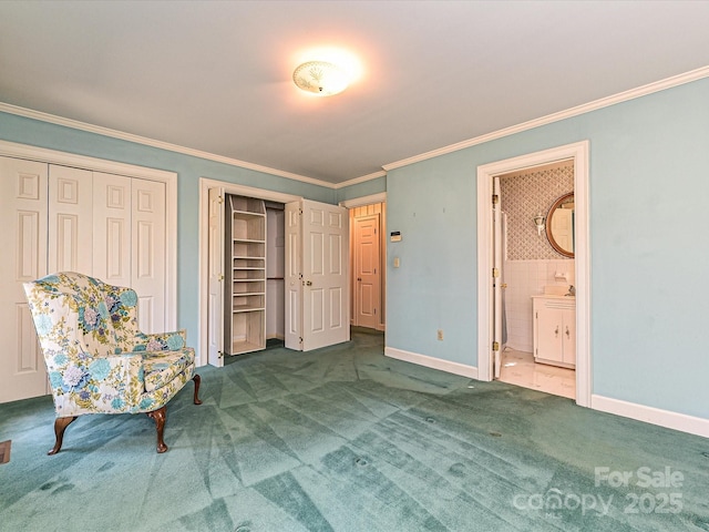 unfurnished bedroom with two closets, baseboards, ornamental molding, carpet, and ensuite bath