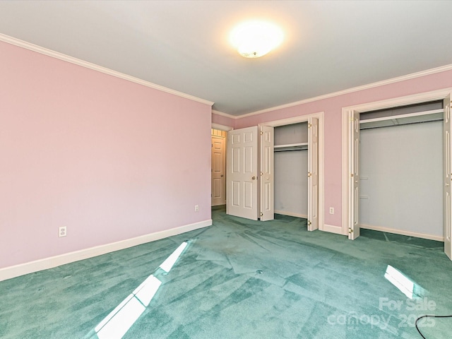 unfurnished bedroom featuring multiple closets, carpet, crown molding, and baseboards