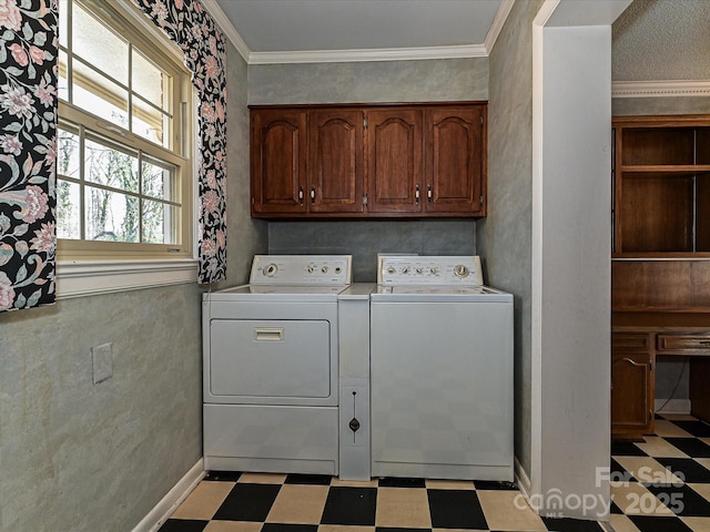 laundry area featuring light floors, washing machine and dryer, cabinet space, and crown molding