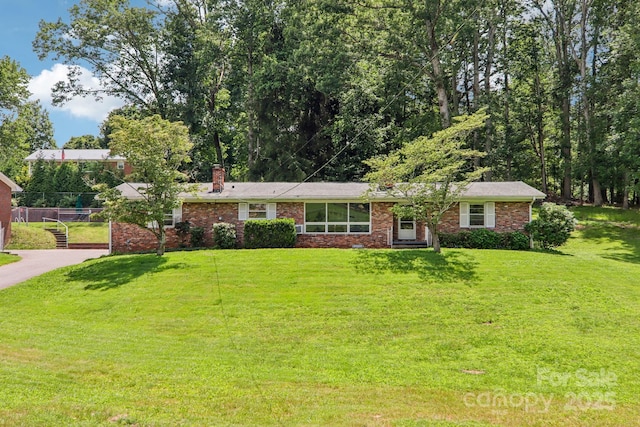 324 Old Leicester Hwy, Asheville, NC 28806 - ranch-style home with a chimney, a front yard, and brick siding