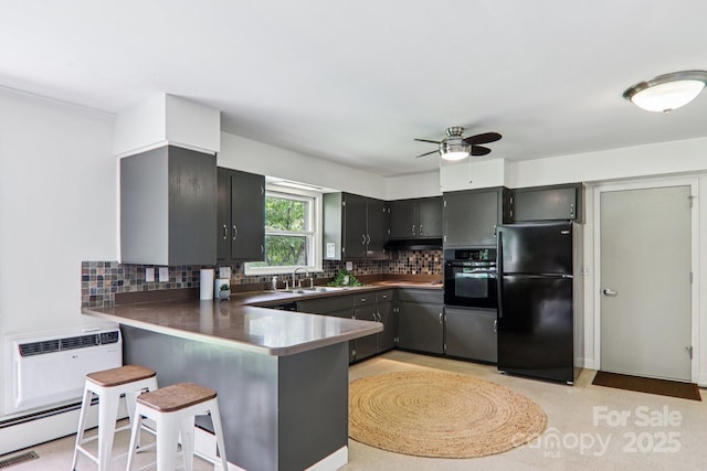 324 Old Leicester Hwy, Asheville, NC 28806 - kitchen featuring black appliances, a ceiling fan, a peninsula, backsplash, and a kitchen breakfast bar