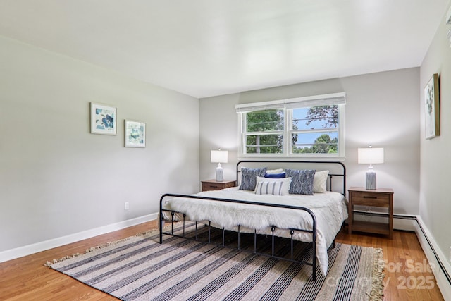 324 Old Leicester Hwy, Asheville, NC 28806 - bedroom featuring wood finished floors and a baseboard radiator