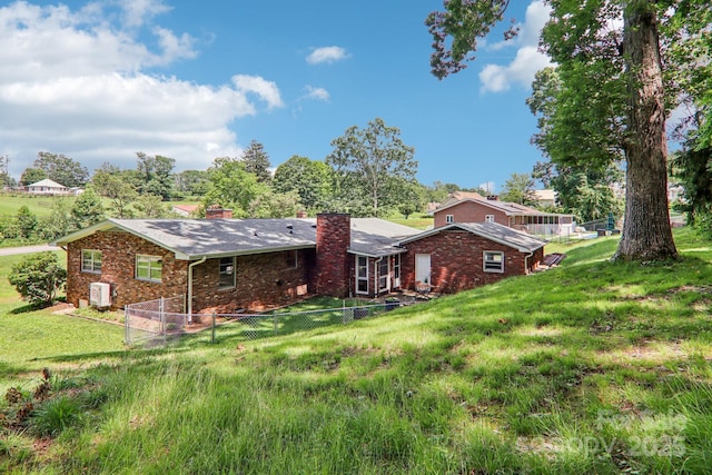 324 Old Leicester Hwy, Asheville, NC 28806 - back of house with a chimney, brick siding, and a fenced backyard