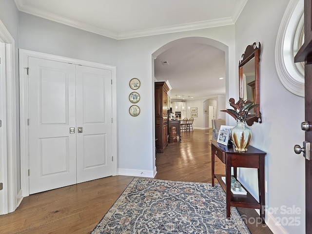 entryway with crown molding and dark hardwood / wood-style flooring