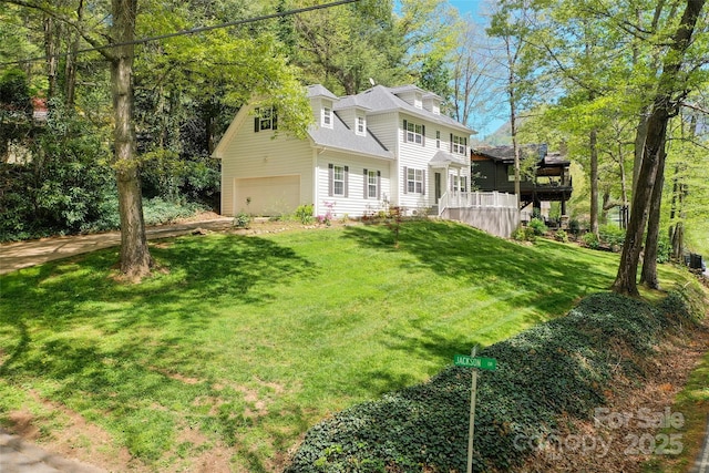 exterior space with a garage, a front lawn, and roof with shingles