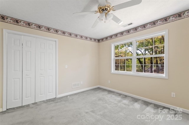 unfurnished bedroom with visible vents, baseboards, and carpet floors