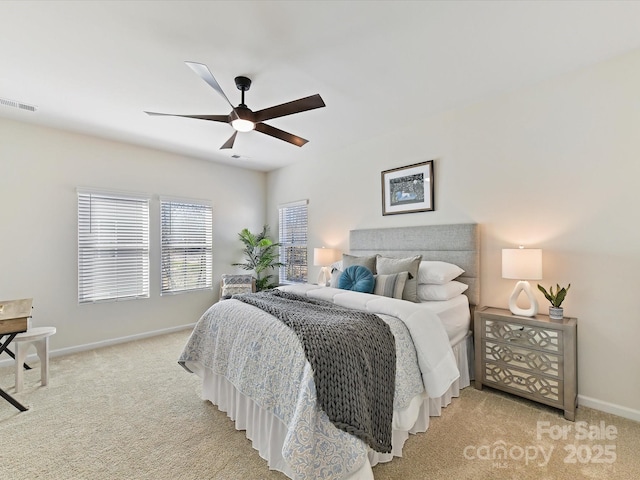 bedroom featuring baseboards, visible vents, ceiling fan, and light colored carpet