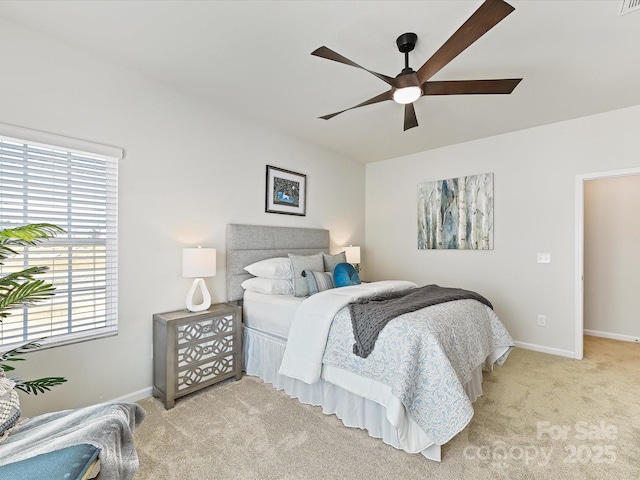 bedroom featuring light carpet, ceiling fan, and baseboards