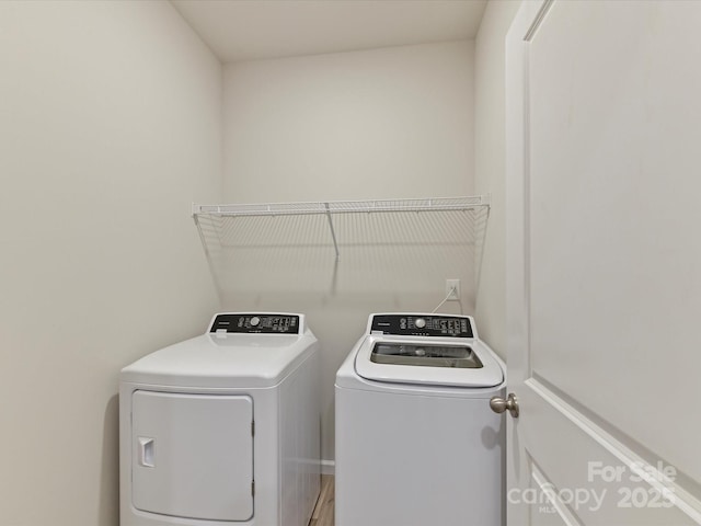 clothes washing area with laundry area and washer and clothes dryer