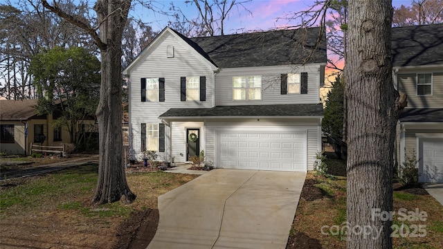 traditional-style home featuring concrete driveway and an attached garage