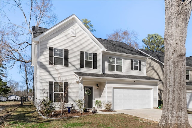 view of front of home with a garage, a front yard, and concrete driveway