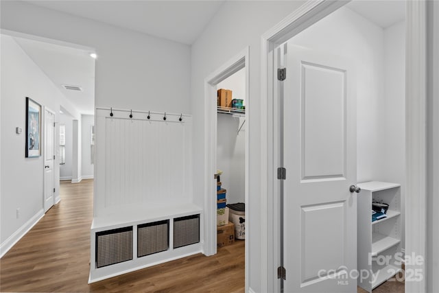 mudroom with wood finished floors, visible vents, and baseboards