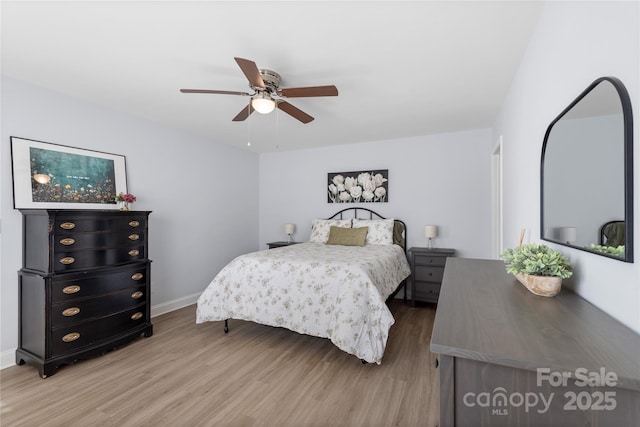 bedroom with ceiling fan, wood finished floors, and baseboards