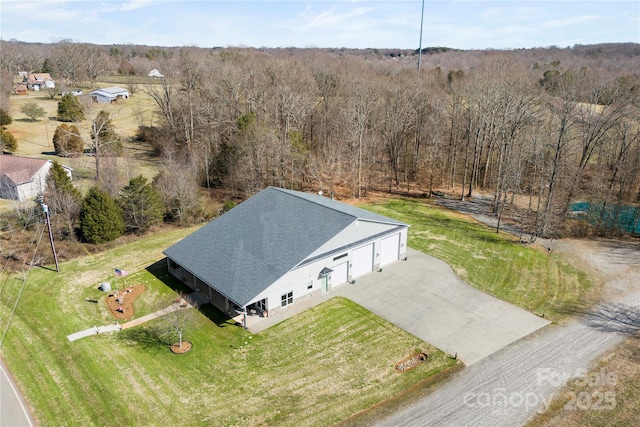 birds eye view of property with a wooded view