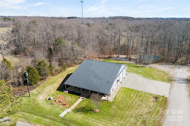 drone / aerial view featuring a view of trees