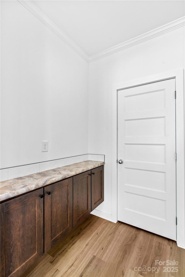 interior space featuring ornamental molding and hardwood / wood-style flooring