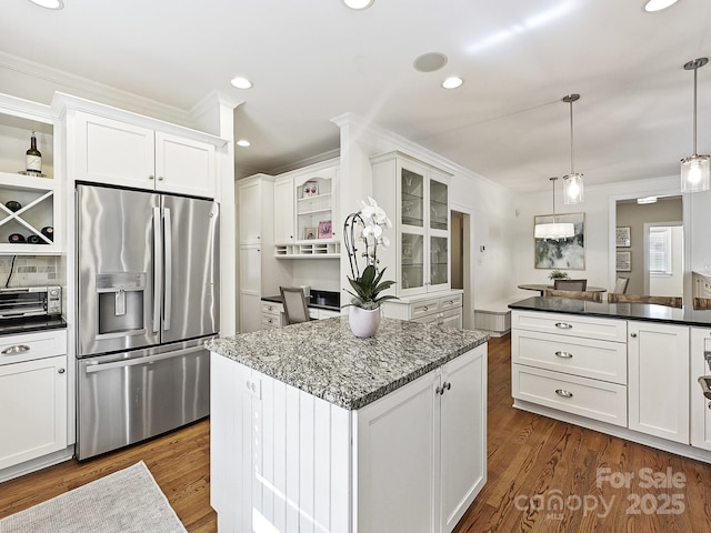 kitchen featuring open shelves, white cabinets, stainless steel refrigerator with ice dispenser, and hanging light fixtures