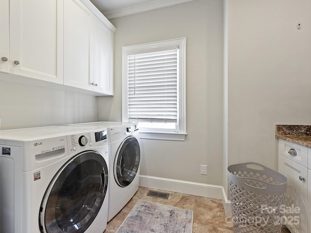 laundry room featuring cabinet space, baseboards, visible vents, washer and clothes dryer, and ornamental molding