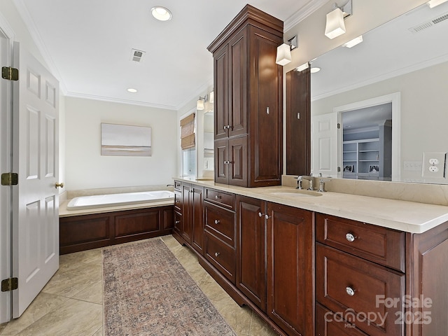 bathroom with crown molding, visible vents, a sink, and a garden tub