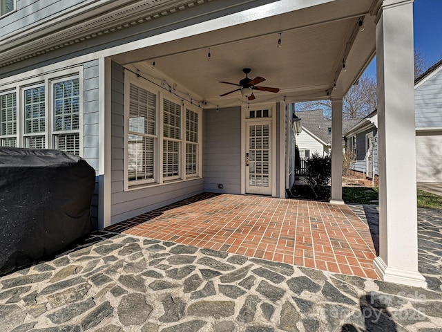 view of patio featuring a grill and a ceiling fan