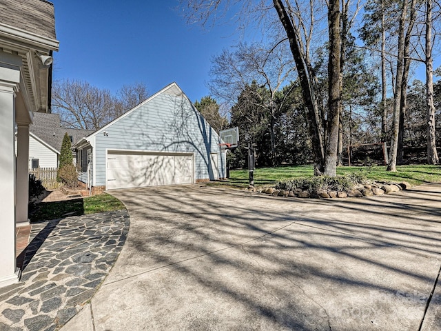 view of side of home with a garage and driveway