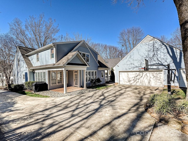 view of front of house featuring french doors, aphalt driveway, and an attached garage