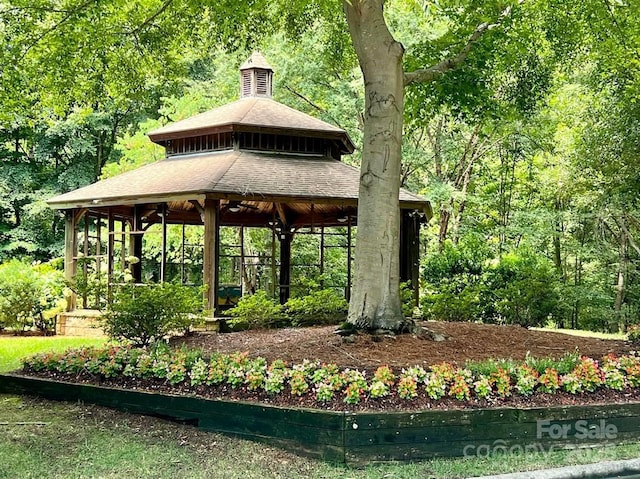 view of property's community featuring a gazebo and a view of trees