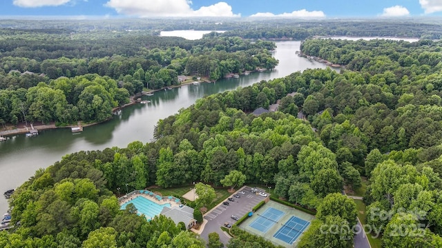 bird's eye view featuring a wooded view and a water view