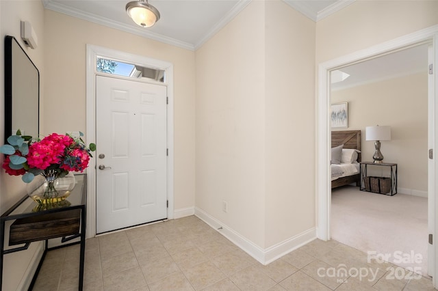 entrance foyer with crown molding, light tile patterned flooring, light colored carpet, and baseboards