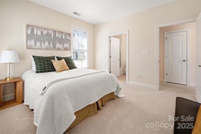 carpeted bedroom with visible vents and baseboards