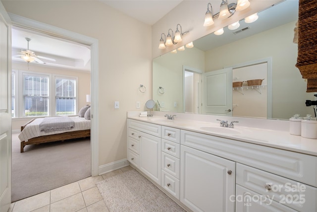 bathroom with a sink, visible vents, double vanity, and ensuite bathroom