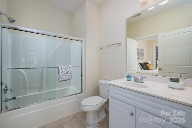 full bath with vanity, visible vents, tile patterned flooring, toilet, and combined bath / shower with glass door