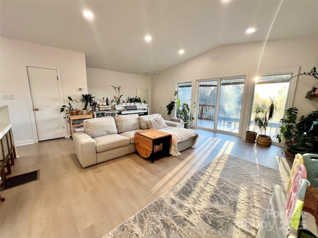 living room with lofted ceiling, light wood finished floors, and recessed lighting